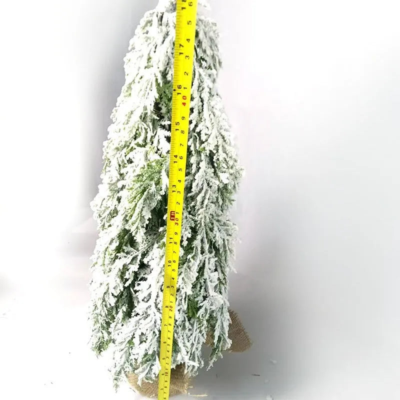 24-inch white snowy plastic desktop Christmas tree with built-in lights and one ornament.