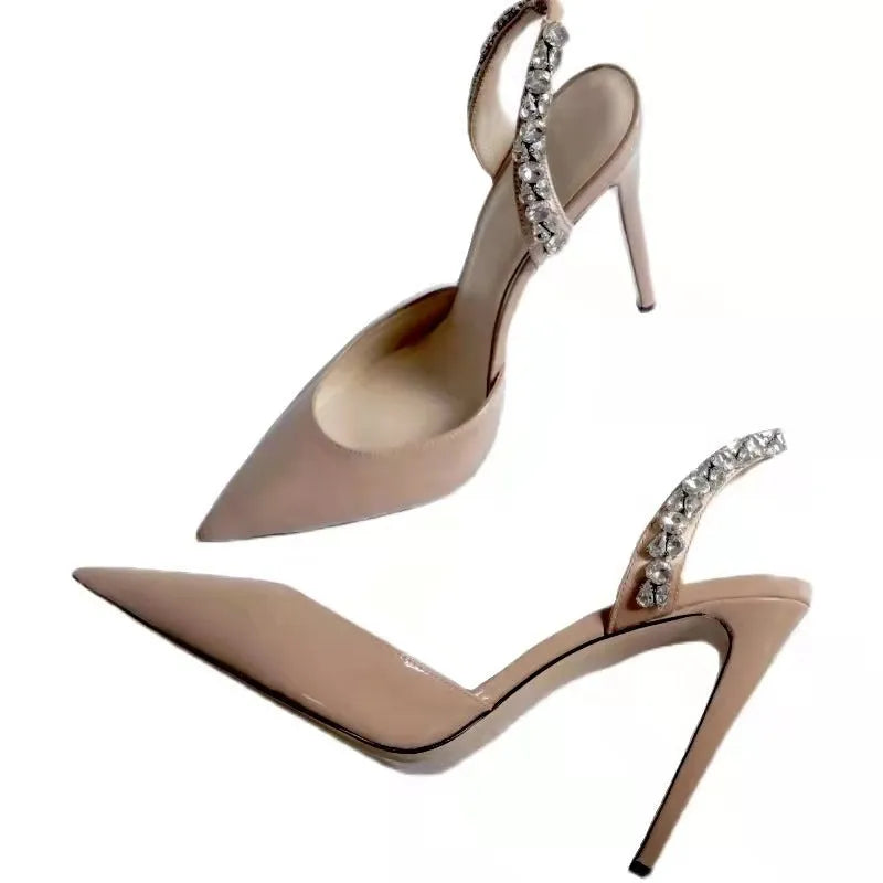 Women's black patent leather pointed toe high heel sandals with rhinestone details on the strap.