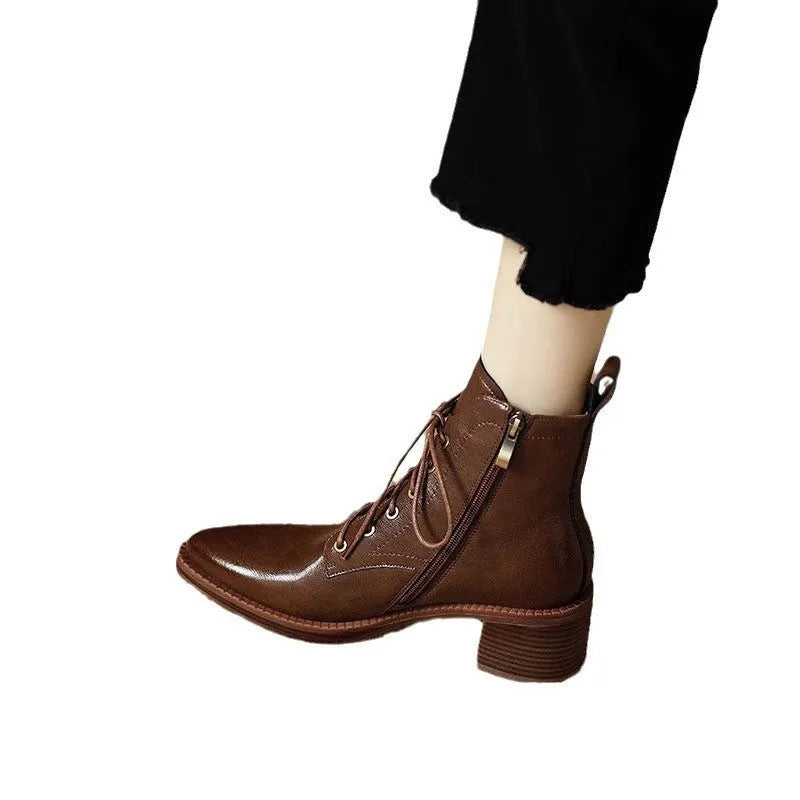 Women's black pointed-toe ankle boots with block heel and short shaft design