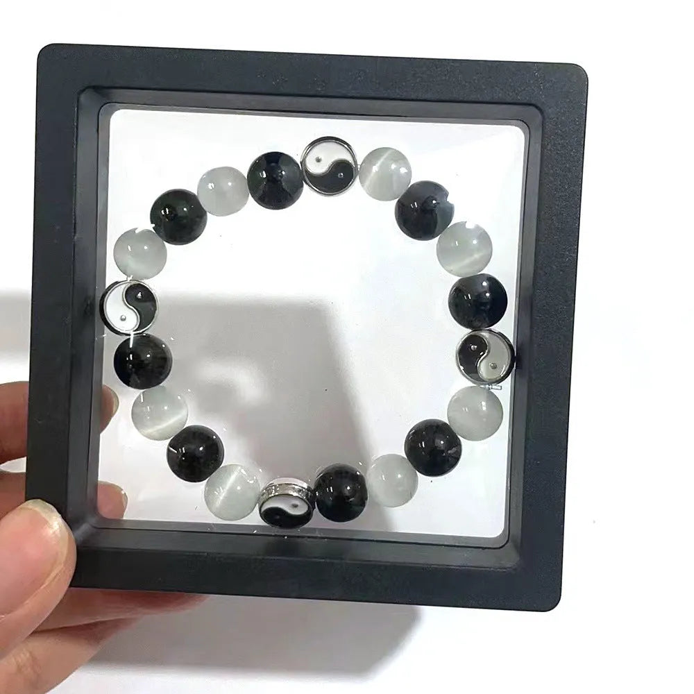 Natural stone Tai Chi bracelet with 10mm polished opal and black agate beads in traditional Chinese beaded design