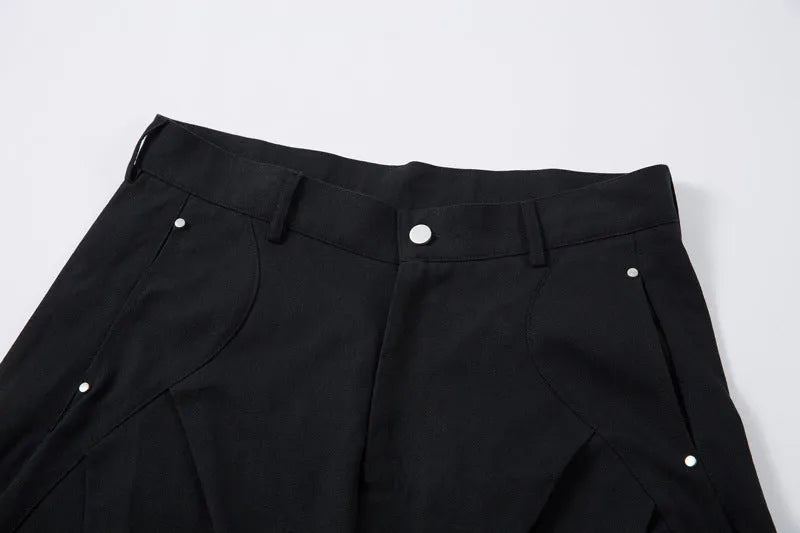 Men's black pleated casual trousers with a loose wide-leg fit and elasticated mid-waist.