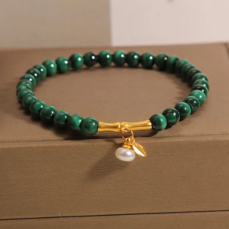 Women's white crystal bracelet with bamboo charm on adjustable metallic chain showing length between 20-24cm