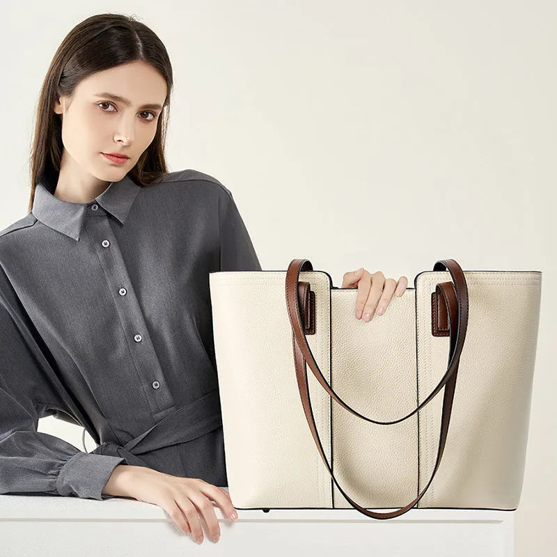 Women's black genuine leather commuter bag with crossbody strap and internal organiser pockets