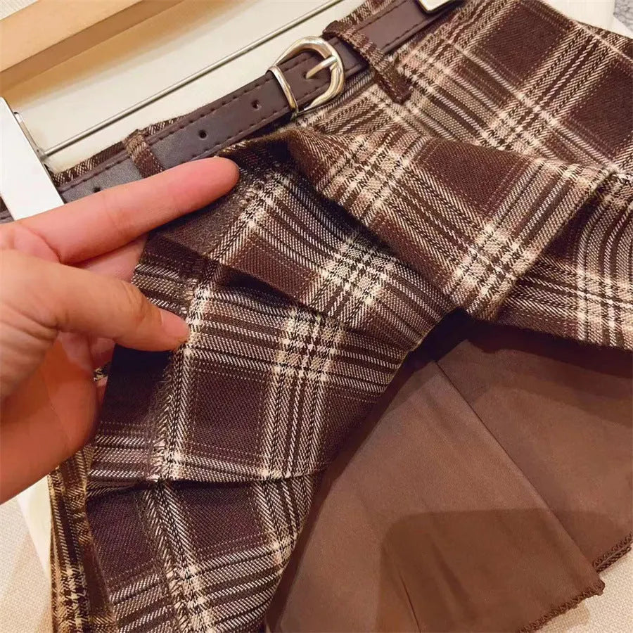 Girls' plaid pattern pleated A-line skirt in cotton blend fabric.