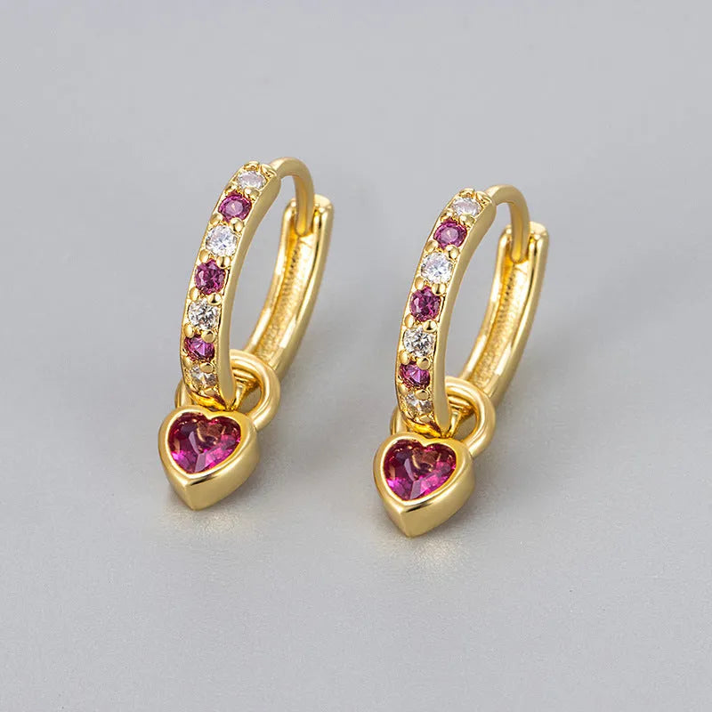 Women's gold-coloured heart drop earrings with a blue zircon stone centre and clip-on fastening.