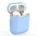 Beige, black, blue and pink coloured silicone protective covers for Apple AirPods cases on a grey background.