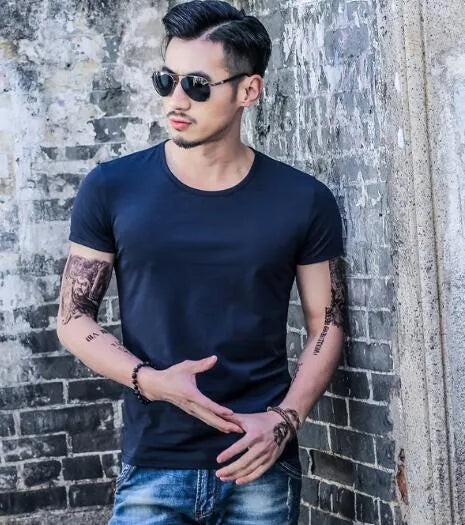Man wearing a lightweight short sleeve summer T-shirt in a solid colour.