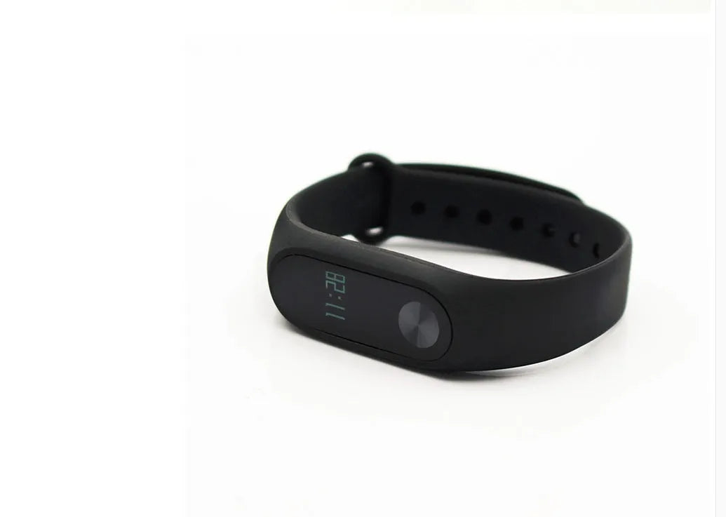 Xiaomi Mi Band 2 black fitness tracker on wrist showing OLED touchscreen display