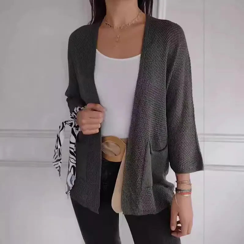 Women's army green waffle knit cardigan coat with nine-quarter sleeves and pockets.
