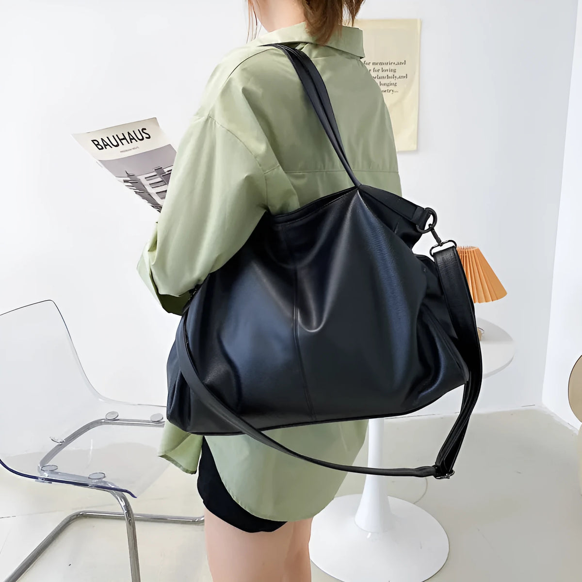 Large soft surface PU messenger bag in horizontal square shape with zip opening and shoulder strap.