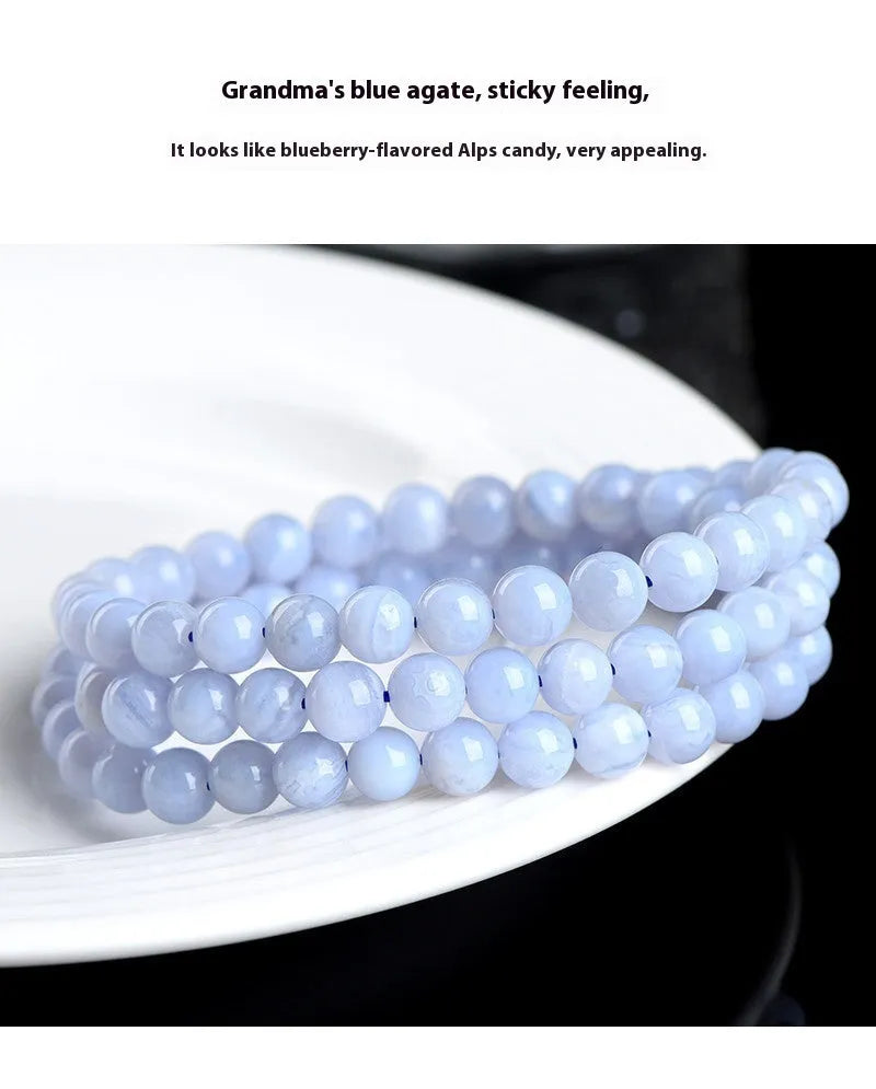 Blue multi-circle patterned agate bracelet with scattered 6-6.8mm beads and Ruyi design detail on a white background.