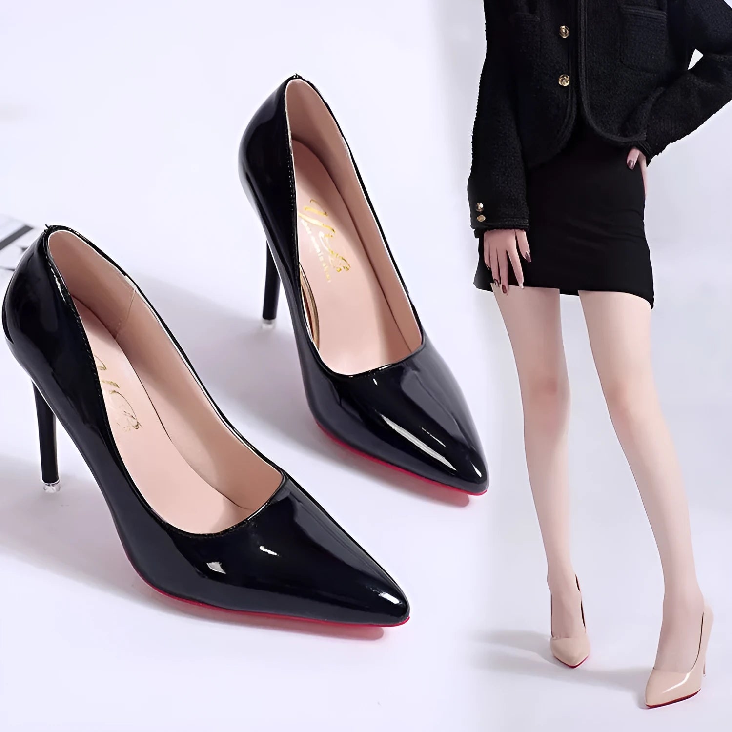 Women's black stiletto heel pointed toe pump shoe on a white background.