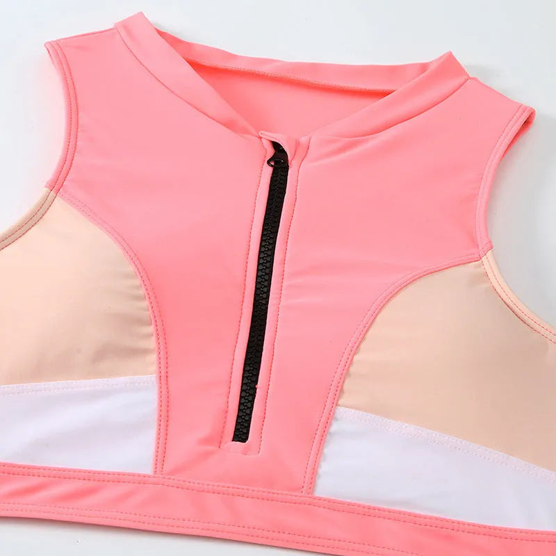 Pink high-waist split bikini swimsuit with matching bra and briefs on solid background