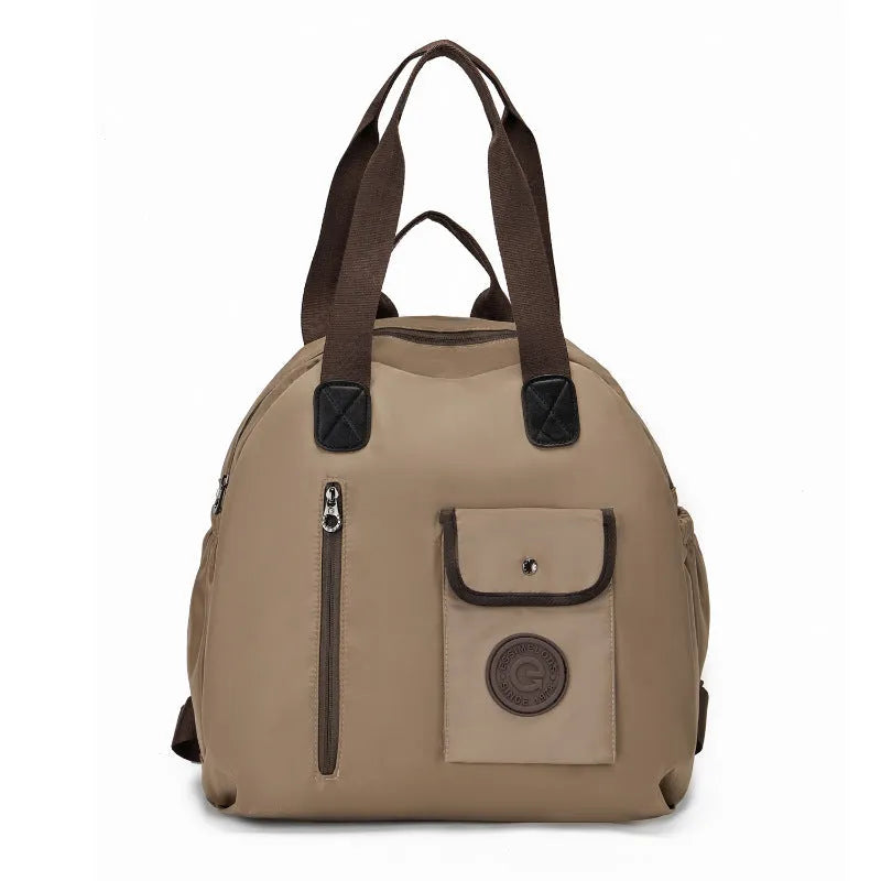 Large lightweight nylon backpack in black, khaki, or green with front sandwich pocket.