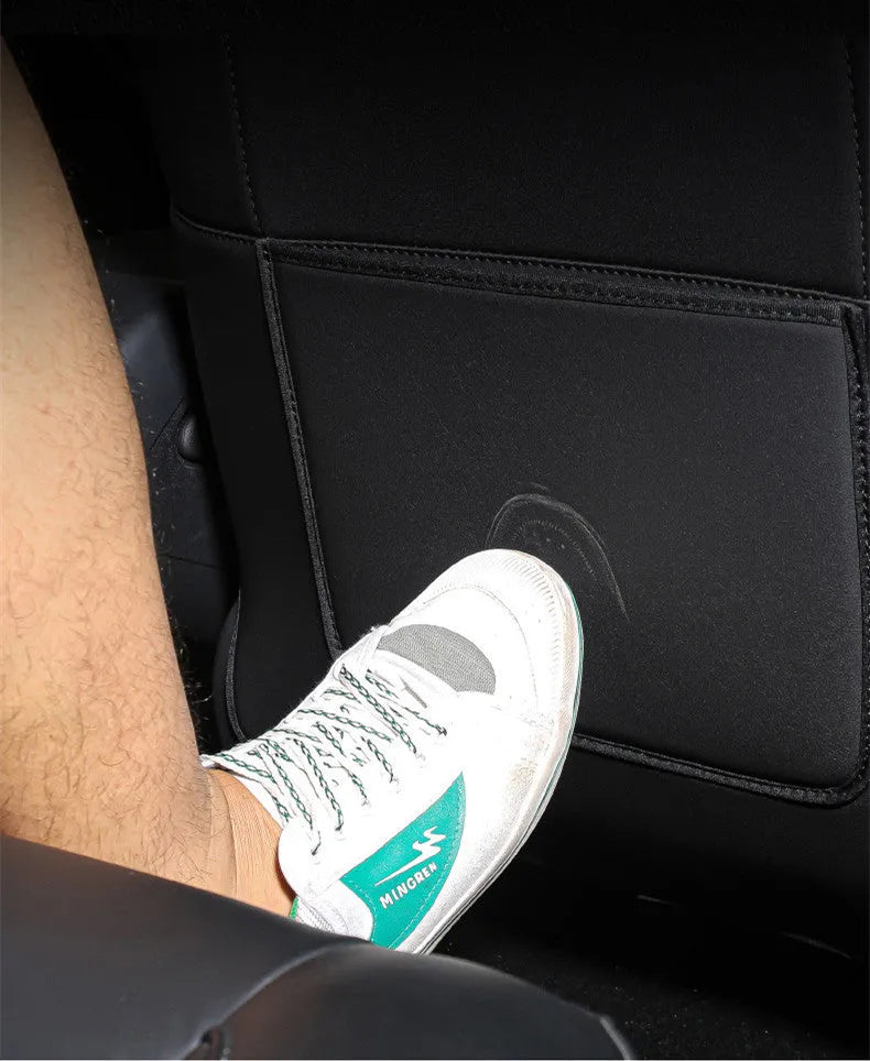 Black leather car rear seat anti-kick protection pad showing full coverage design.