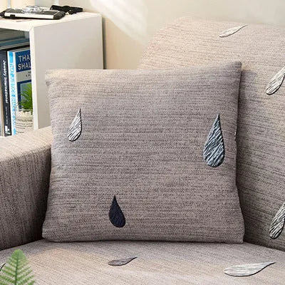 Geometric abstract print stretch sofa slipcover on a modern sofa