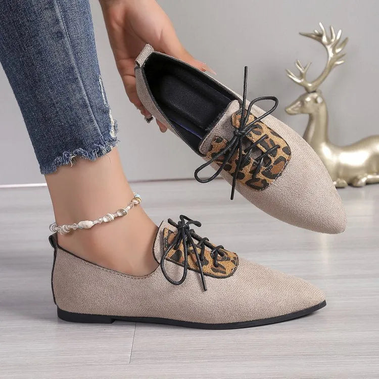 Beige leopard print women's pointed toe pumps with a faux PU upper and rubber sole.