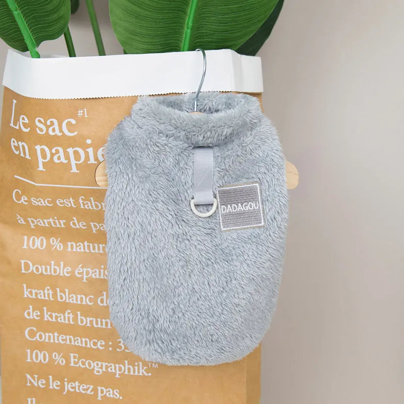 Fluffy blue coral fleece pet jacket with multi-coloured pull ring fastening on a dog model.