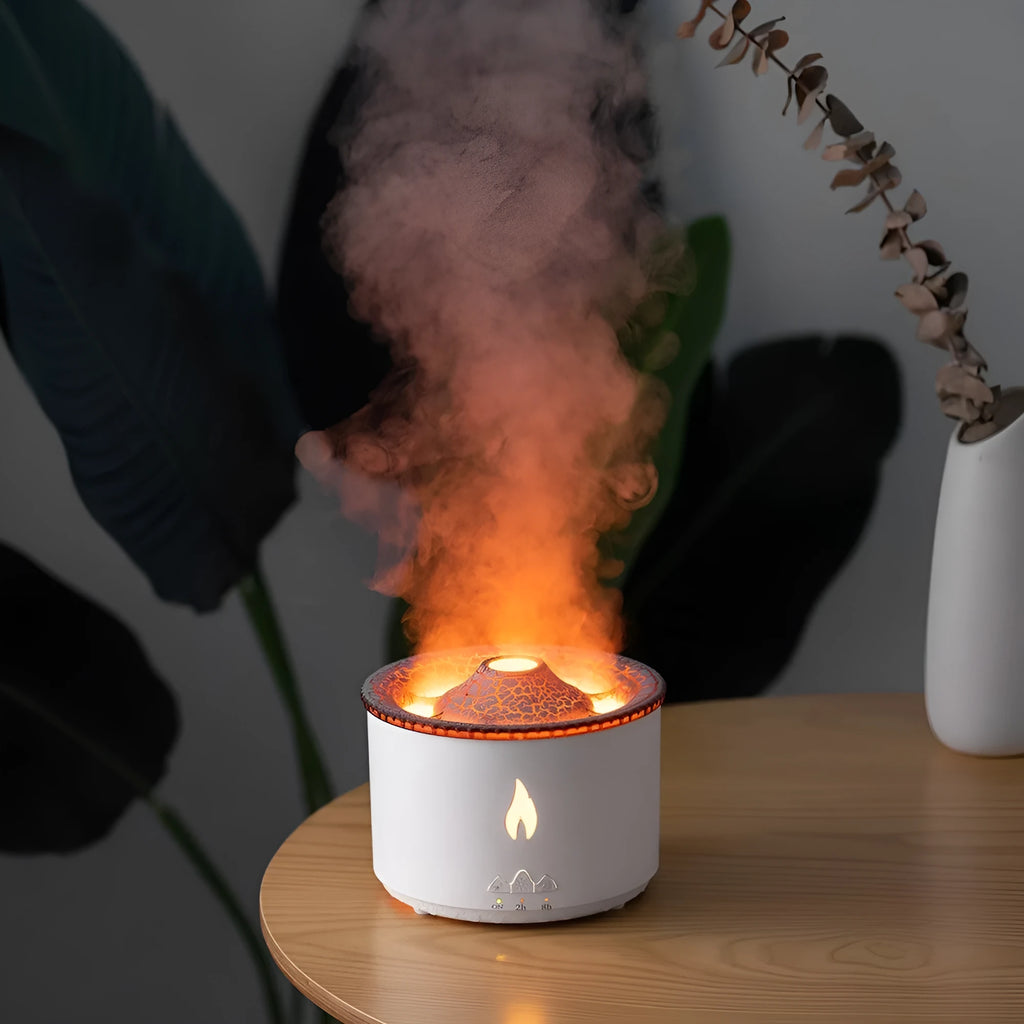 Volcanic-shaped humidifier emitting a two-colour mist from its spray ring on a table.
