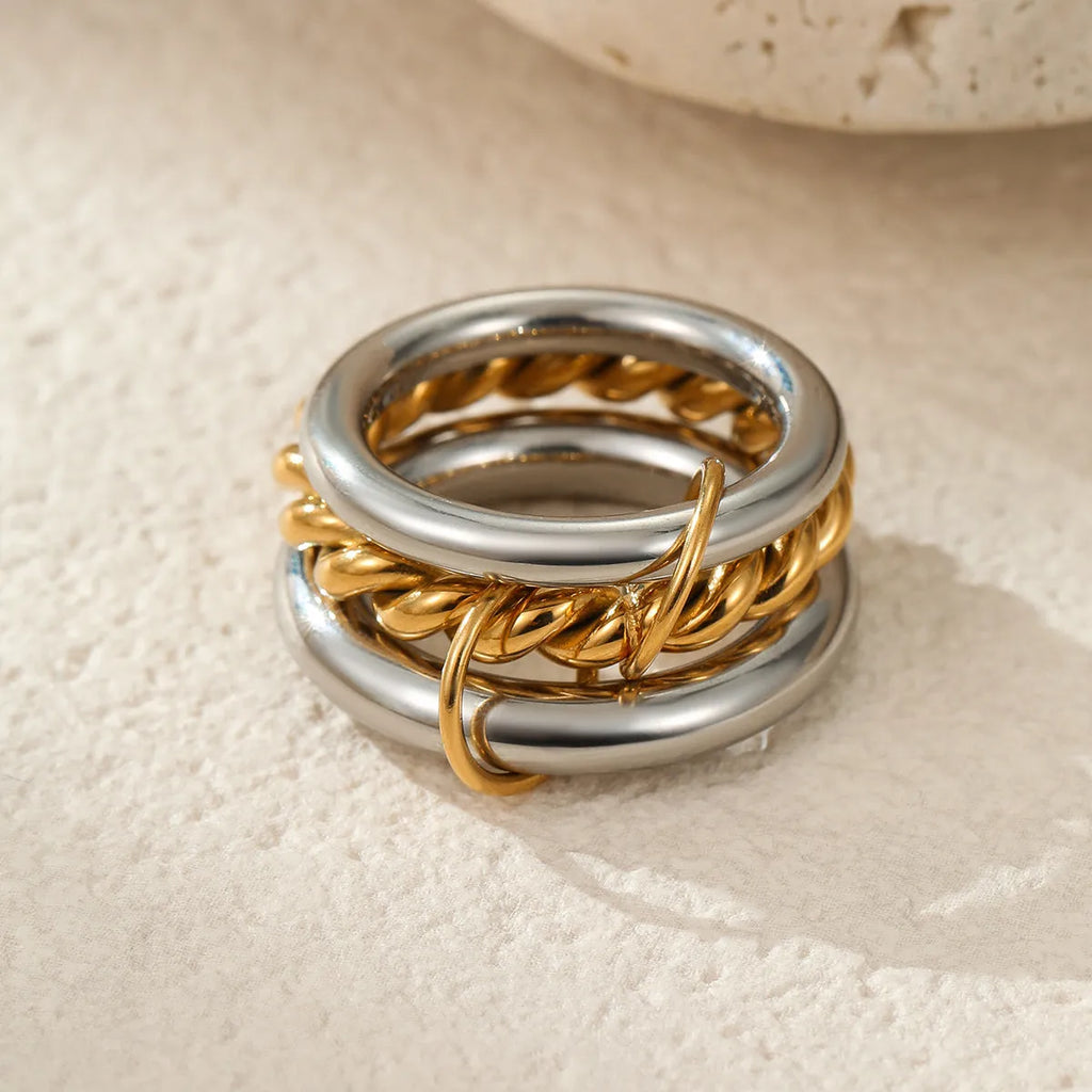Stacked colour matching stainless steel rings with 18K gold electroplating in exaggerated jewellery styles