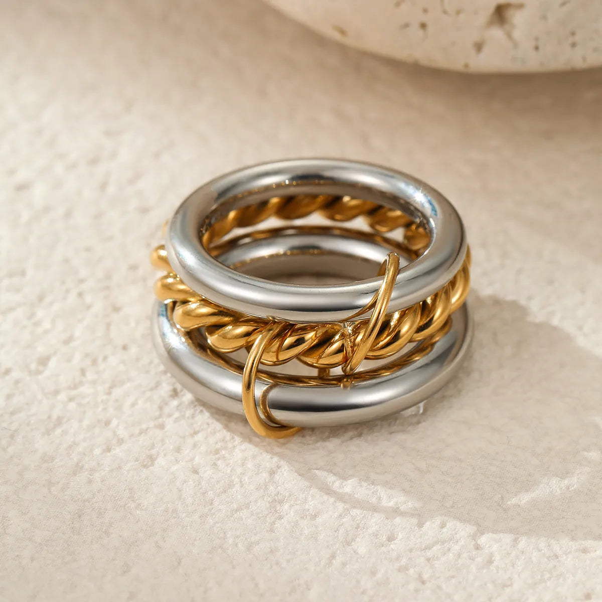 Stacked colour matching stainless steel rings with 18K gold electroplating in exaggerated jewellery styles