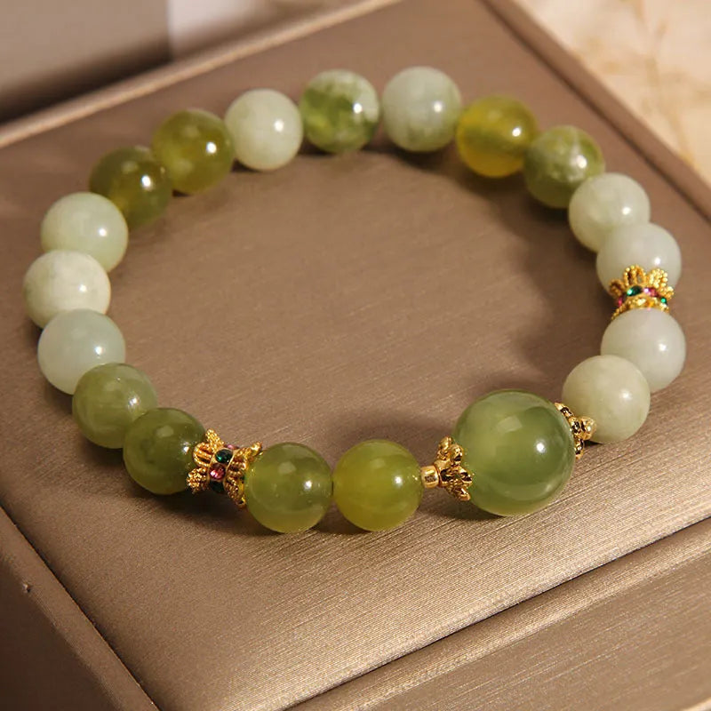 Women's jade bracelet in Xiuyan jade green colour with original design on wrist.