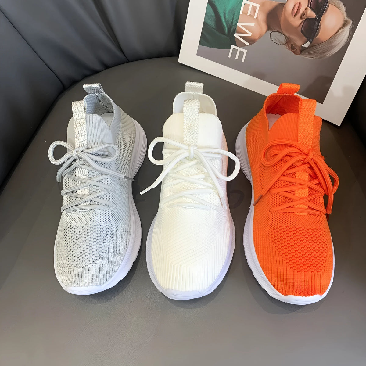 Women's creamy white low-top running shoes with a Flyknit upper and mesh detailing on a flat rubber sole.