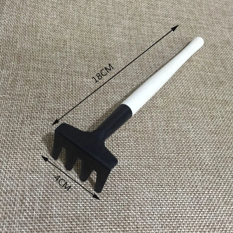 14-piece succulent gardening tool set showing mini shovels, tweezers, watering can, rake, and air blower on a table