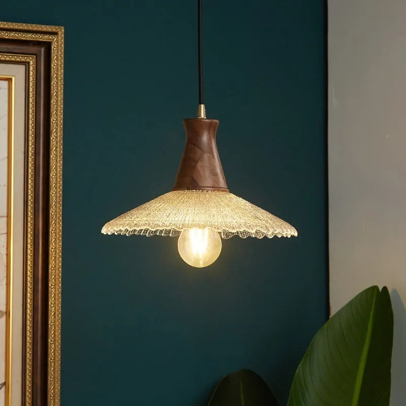 Retro wood and brass chandelier with glass shade in three size options for ceiling mounting.