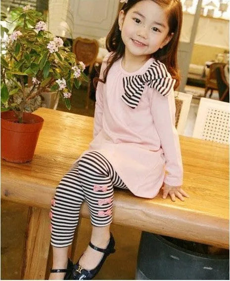 A pink cotton blend clothing set for a young girl, shown on a hanger.