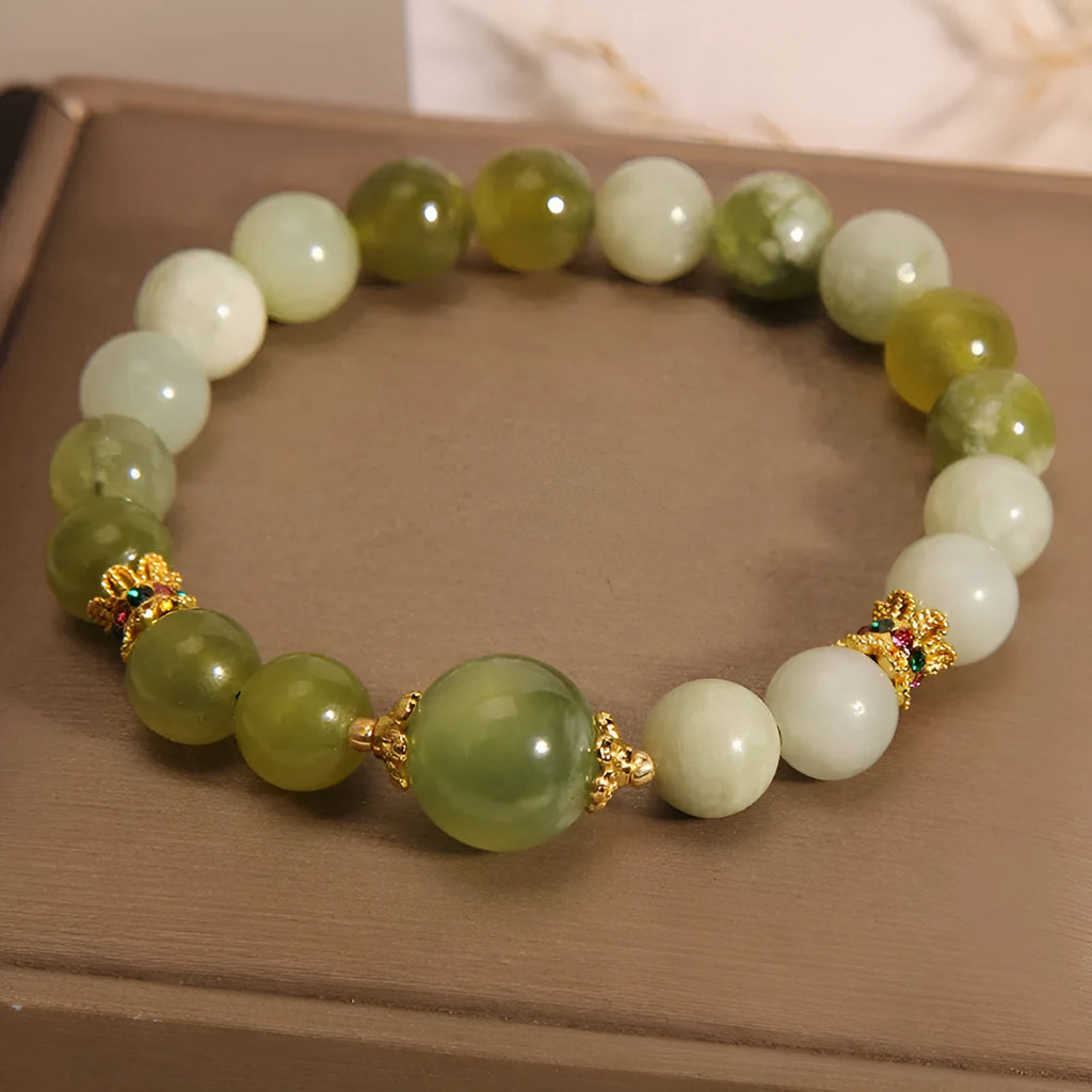 Women's jade bracelet in Xiuyan jade green colour with original design on wrist.
