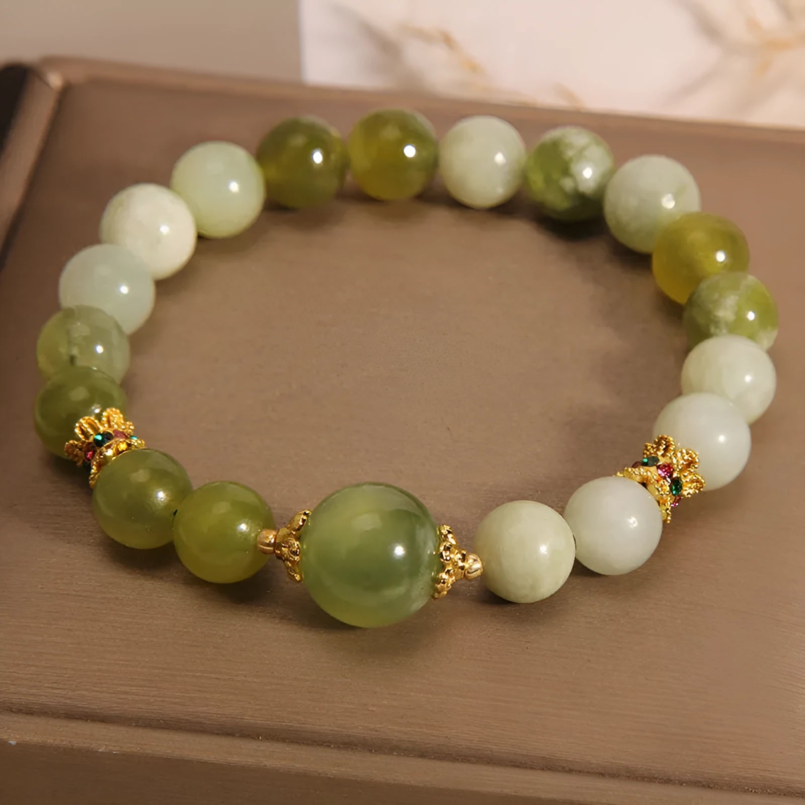 Women's jade bracelet in Xiuyan jade green colour with original design on wrist.