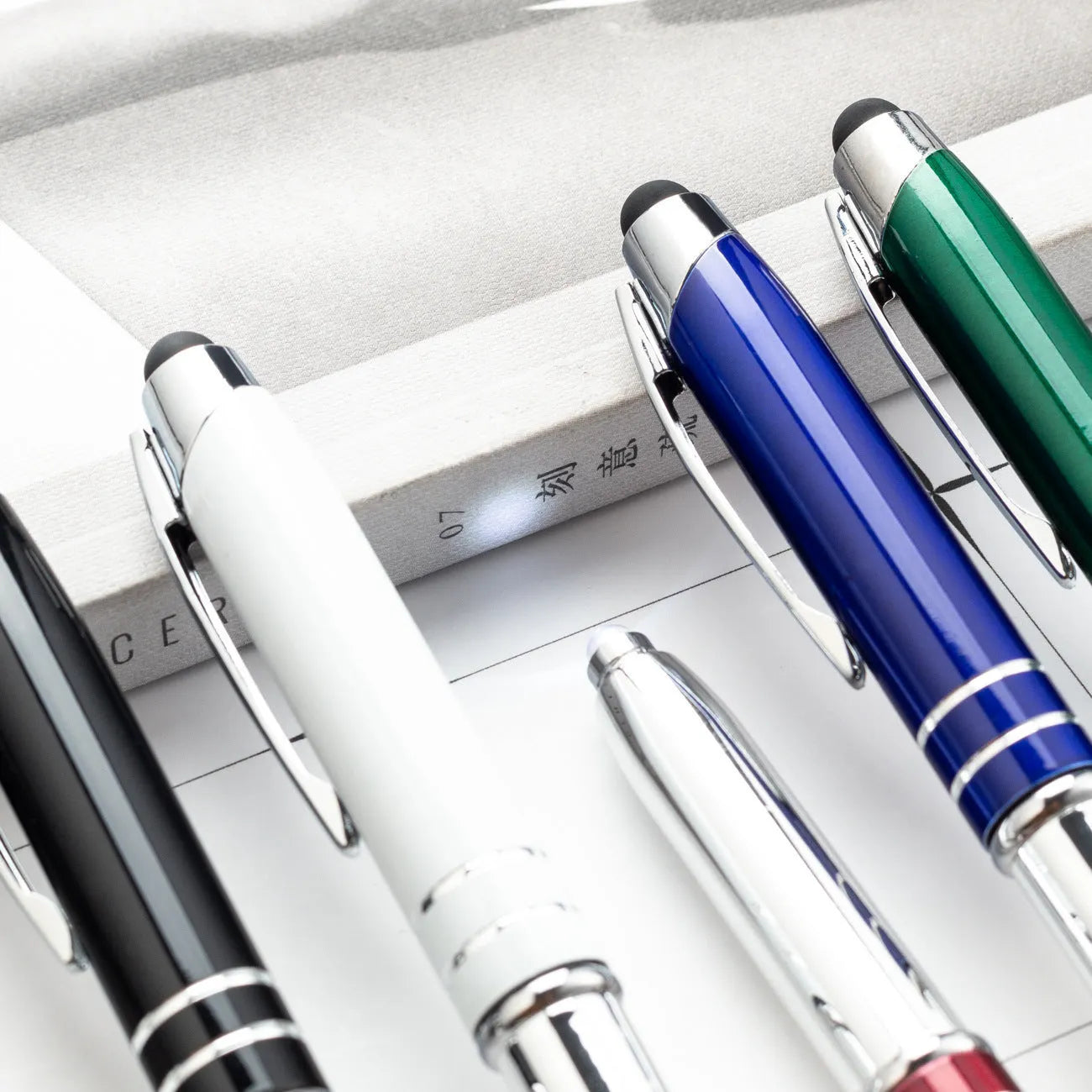 Red metal multifunctional stylus ballpoint pen with LED light and capacitive tip.