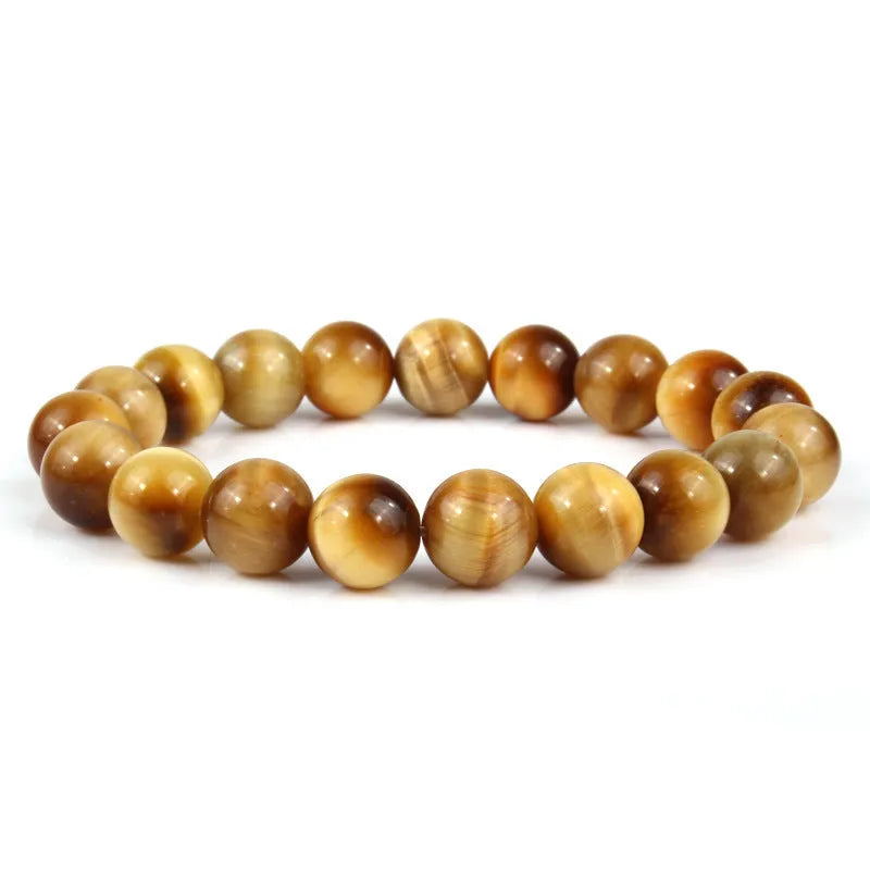 Natural tigereye crystal beaded bracelet with round beads, shown in a selection of colours and sizes on a wrist.