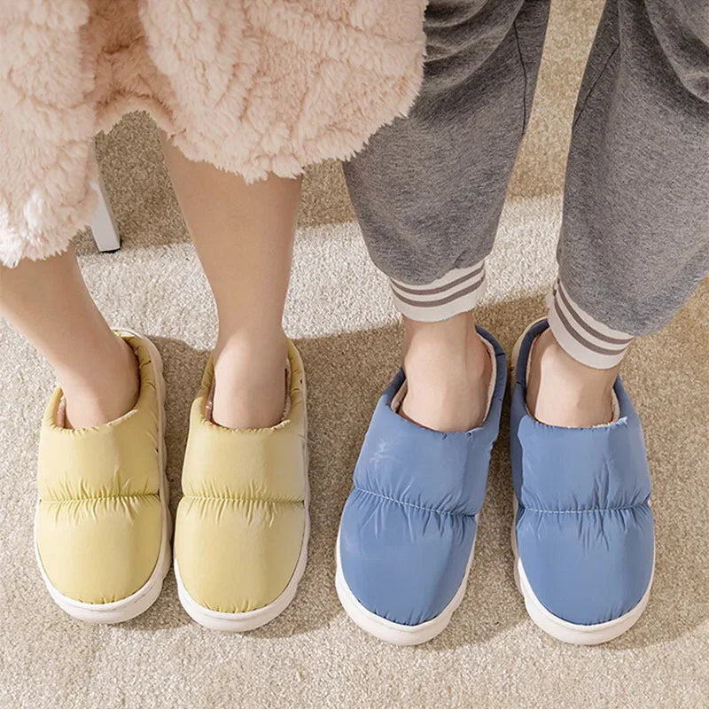 A pair of thick-soled plush slippers with artificial leather uppers and non-slip rubber soles in a choice of five colours.