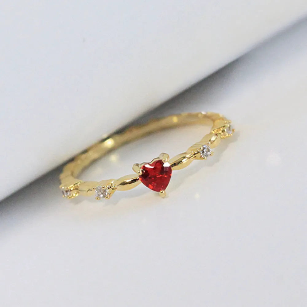 Gold or silver electroplated peach heart fashion ring with zircon stone accents on a copper band.
