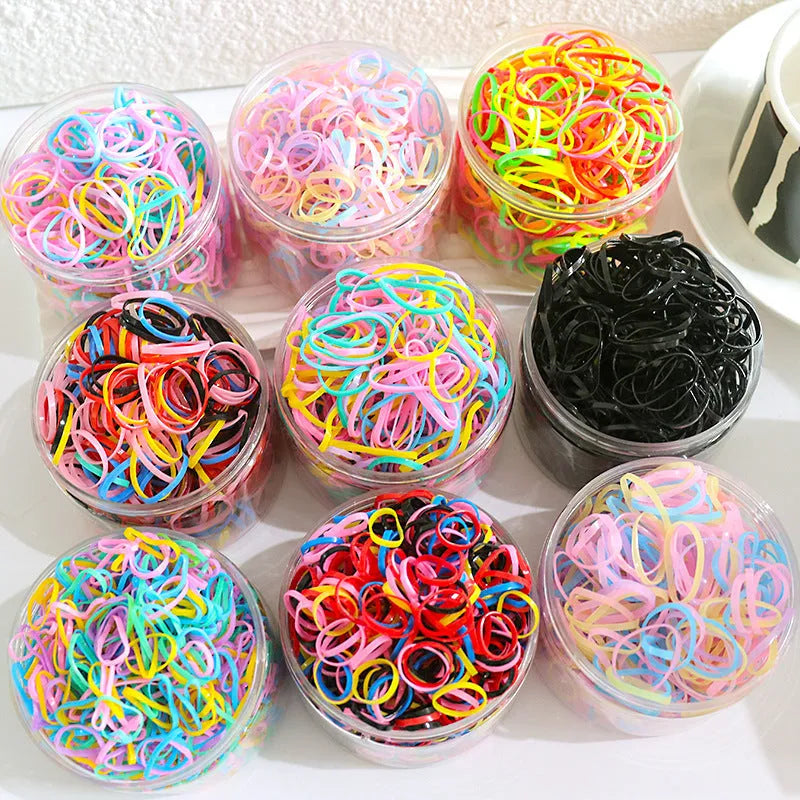Multi-colour TPU baby hair elastics for toddlers stored in a clear reusable container, showing small and large size options.