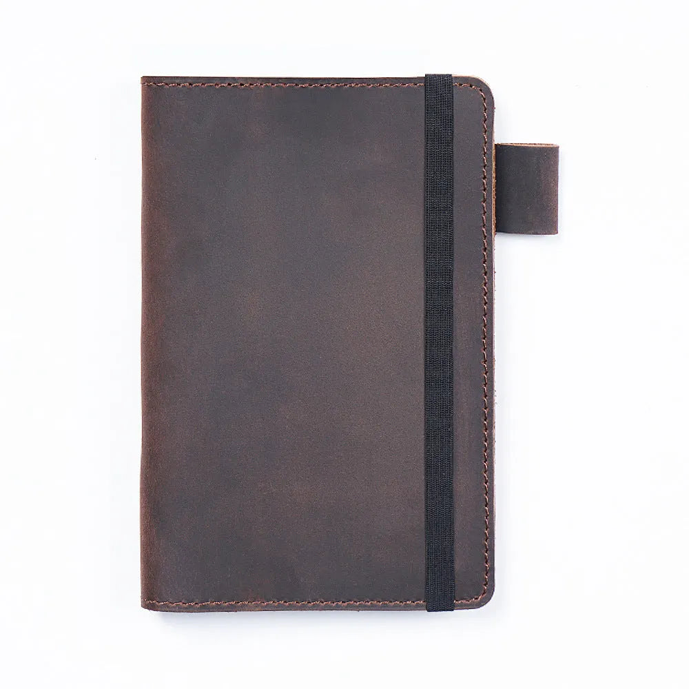 Handmade cowhide leather notebook open showing 100g wood-free paper with dark green cover
