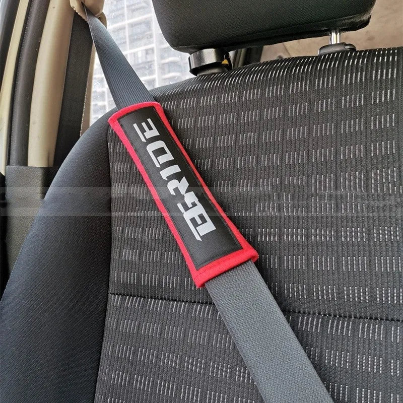 Car seat belt shoulder pads in black, blue, and red colours showing cotton sponge cloth with embroidery weaving