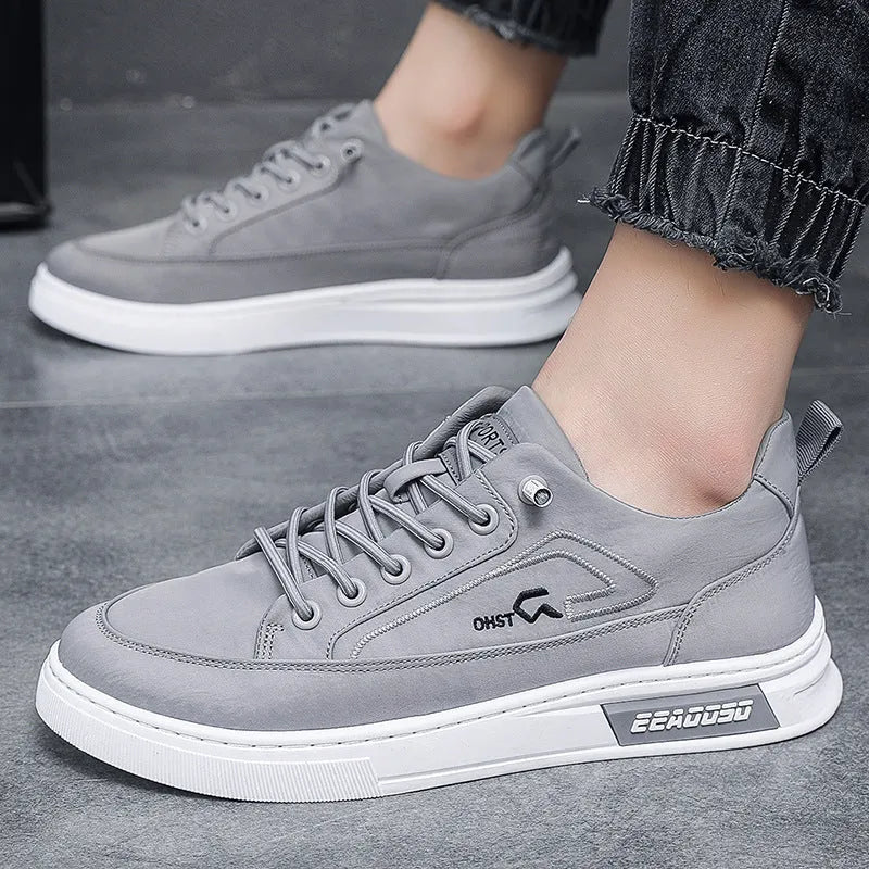 Grey men's canvas casual shoes with lace-up front and decorative stitching details