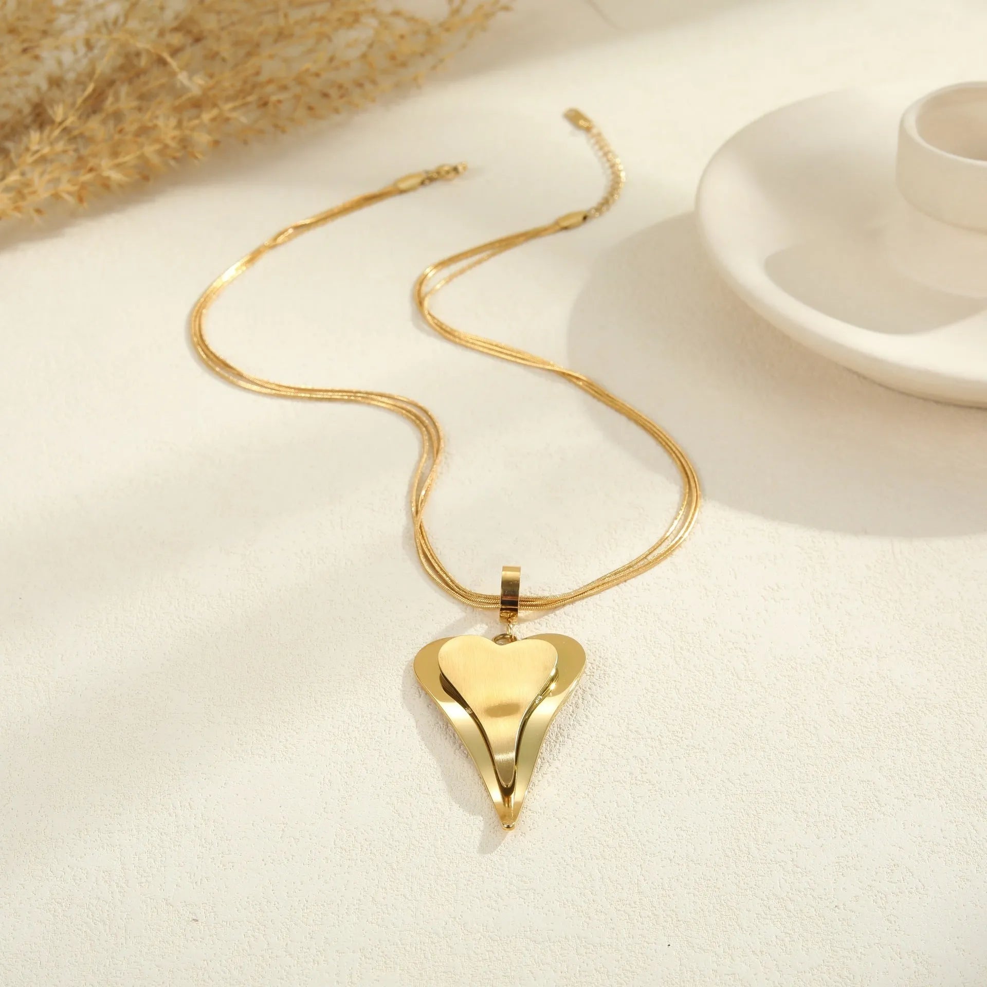 Women's stainless steel necklace with geometric pendant on double heart snake bones chain