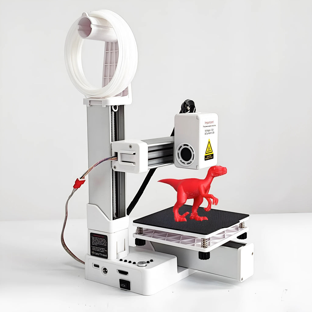 White EasyThreed K10 3D printer on a desk with power cord and instruction manual.