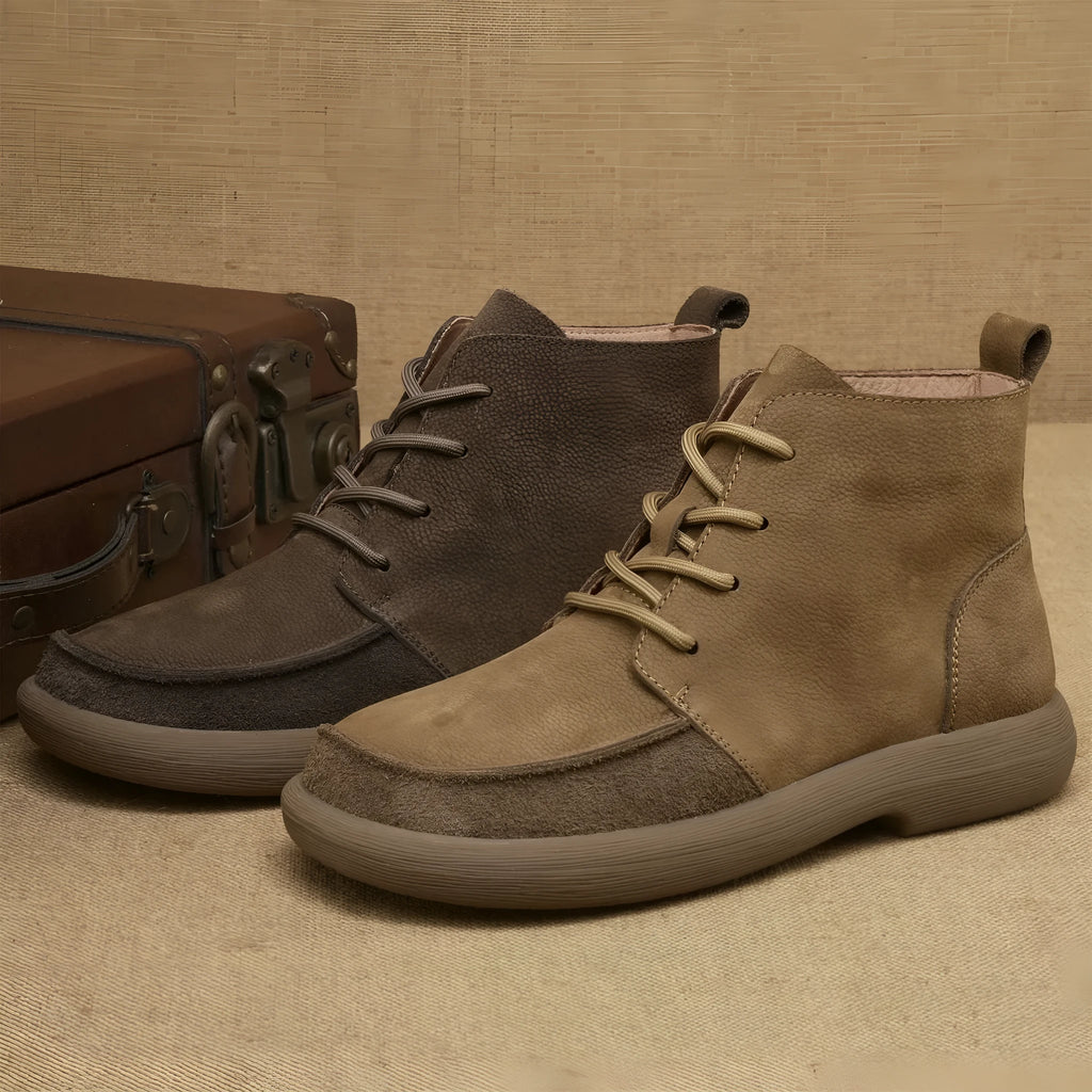 Grey genuine leather Martin boots with lace-up front and wedge heel on a plain background.