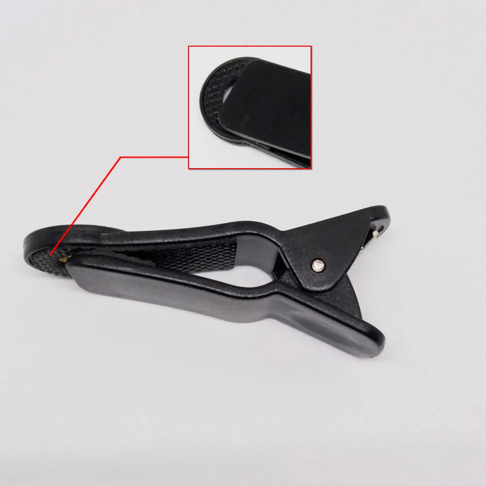 12x telescopic zoom lens with universal clip attached to a mobile phone for outdoor filming.