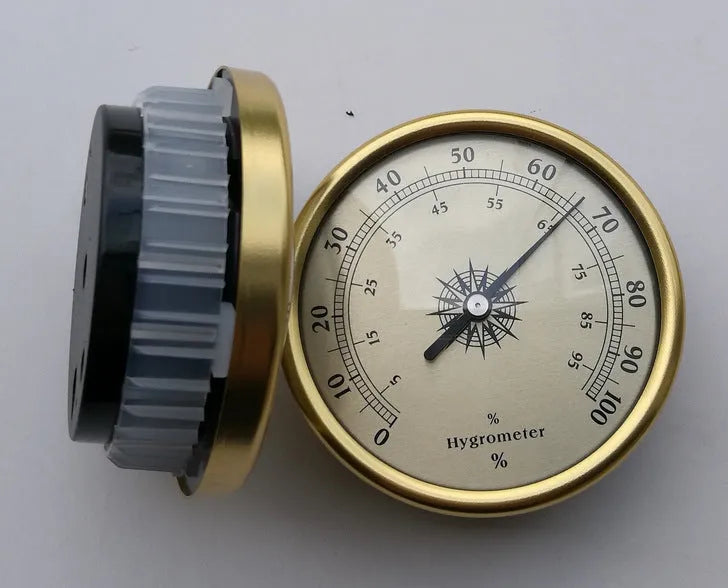 Silver aluminium analog thermometer and hygrometer with a round dial showing temperature and humidity scales.
