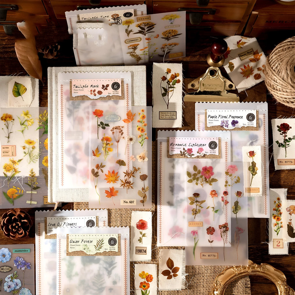 Huazhisen art sticker material pack showing printed transfer paper and cotton linen sheets in forest and romantic designs.
