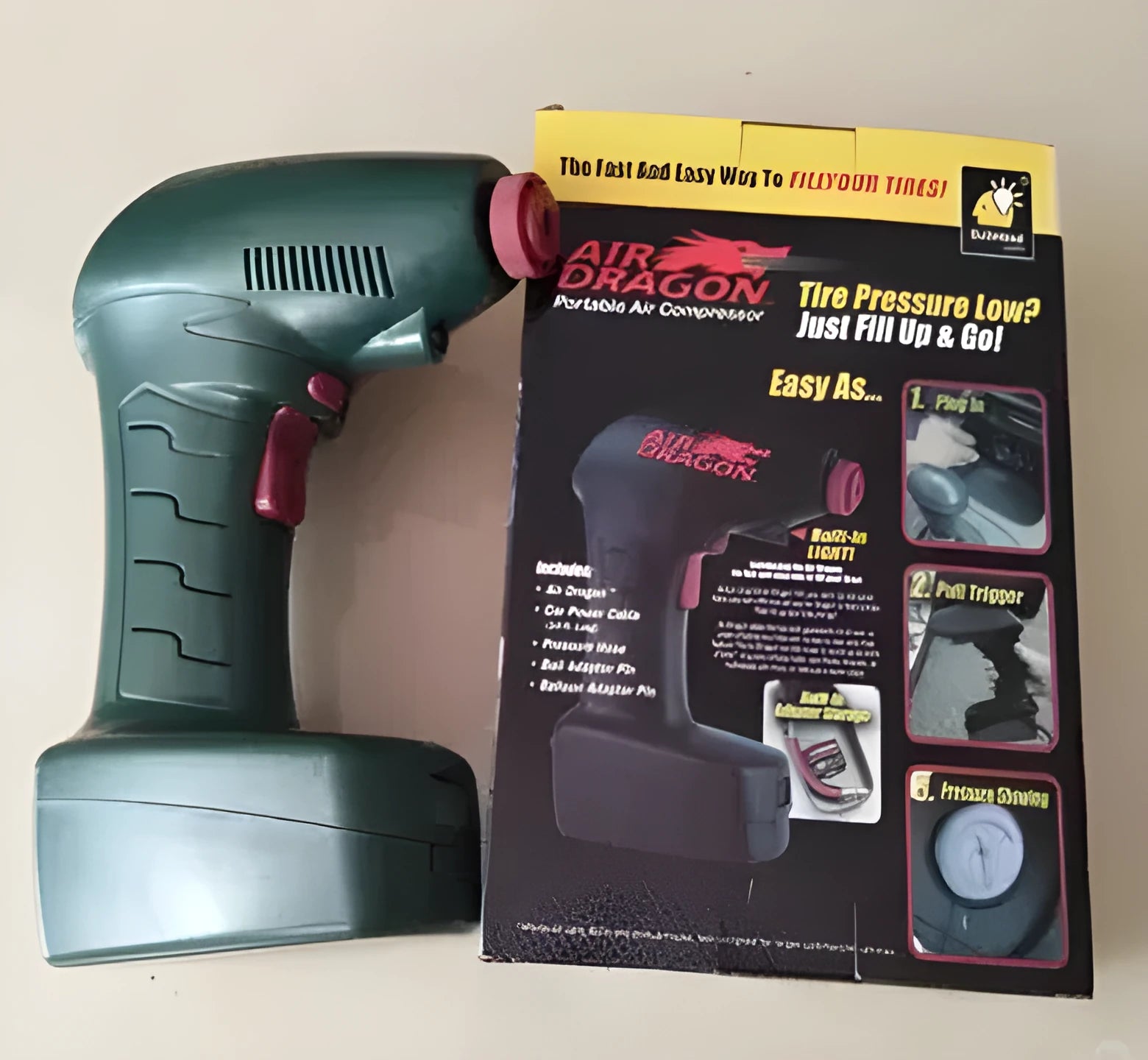 Black portable electric car air pump with motor and inflation hose for tyre pressure maintenance.