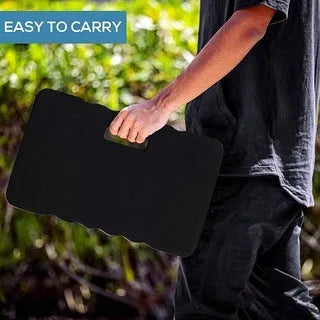 Blue Eva foam garden kneeler pad with handles and side pockets on grass.