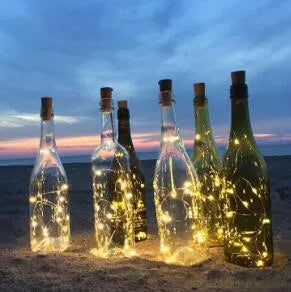 Flexible copper wire LED string lights wrapped around wine bottle with warm white illumination