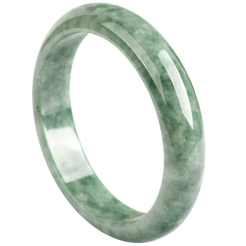 A simple dark pea green natural jade ring bracelet for women on a white background.